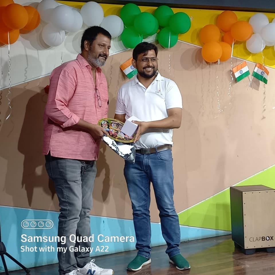 Dr. Niraj Jha giving award to an employee of Hanuman care